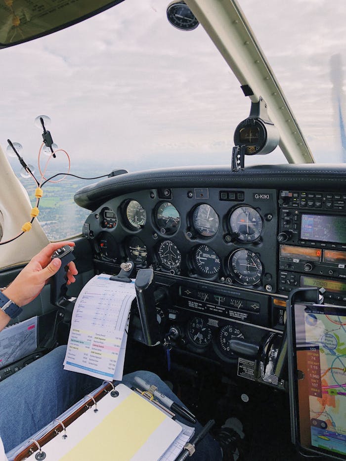 A cockpit view showing aircraft instruments and pilot controls in a small airplane.